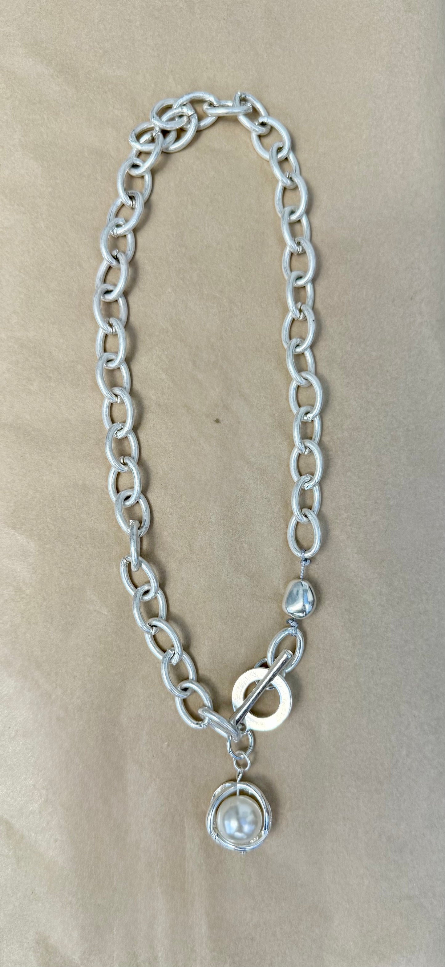 Silver chain-link Toggle Necklace with a Pearl Ball Pendant.