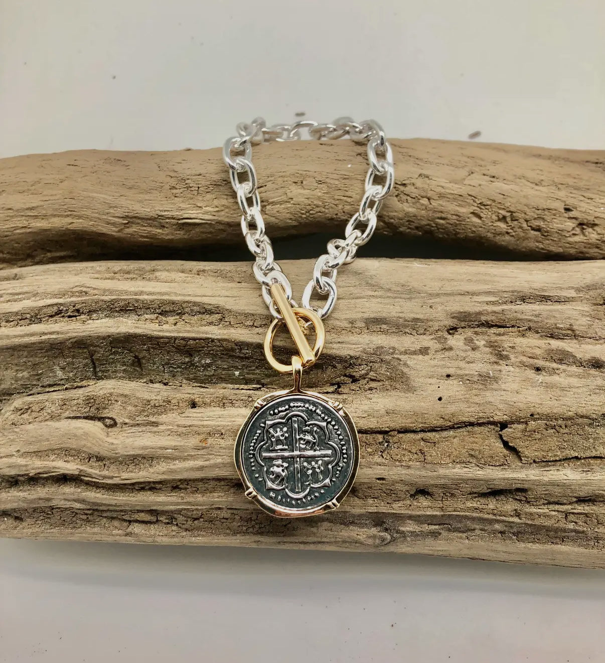 Two-Tone Chain Link Toggle Bracelet with Silver Coin Pendant Edged in Gold.