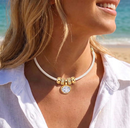 Gold Oval Crystal & Gold Charms on a White/Light Cream Satin Rope Necklace.