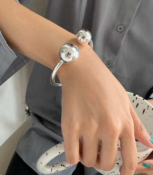 Silver Steel Bangle Bracelet with Ball Accents.