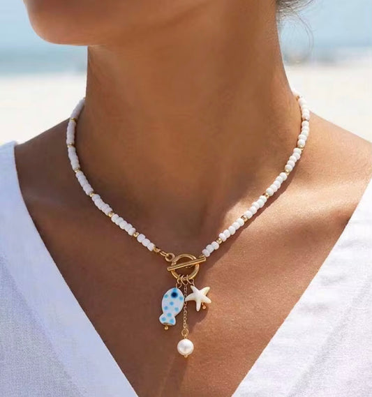 White & Gold Ceramic Beaded Toggle Necklace with White & Blue Fish, Star and Pearl pendants.