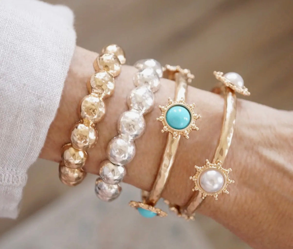 Suncrest Glow - Gold Hammered Stretch Bangle Bracelet with Pearl Suncrest Accents.