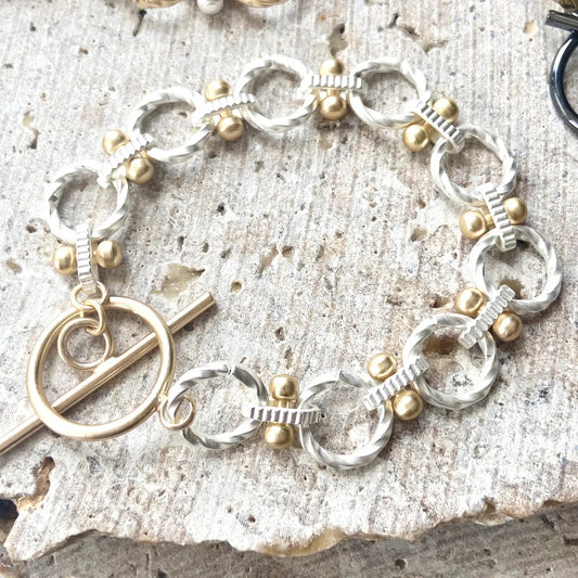 Two-Tone Toggle Chain Bracelet - Matte Silver with Gold Accents.